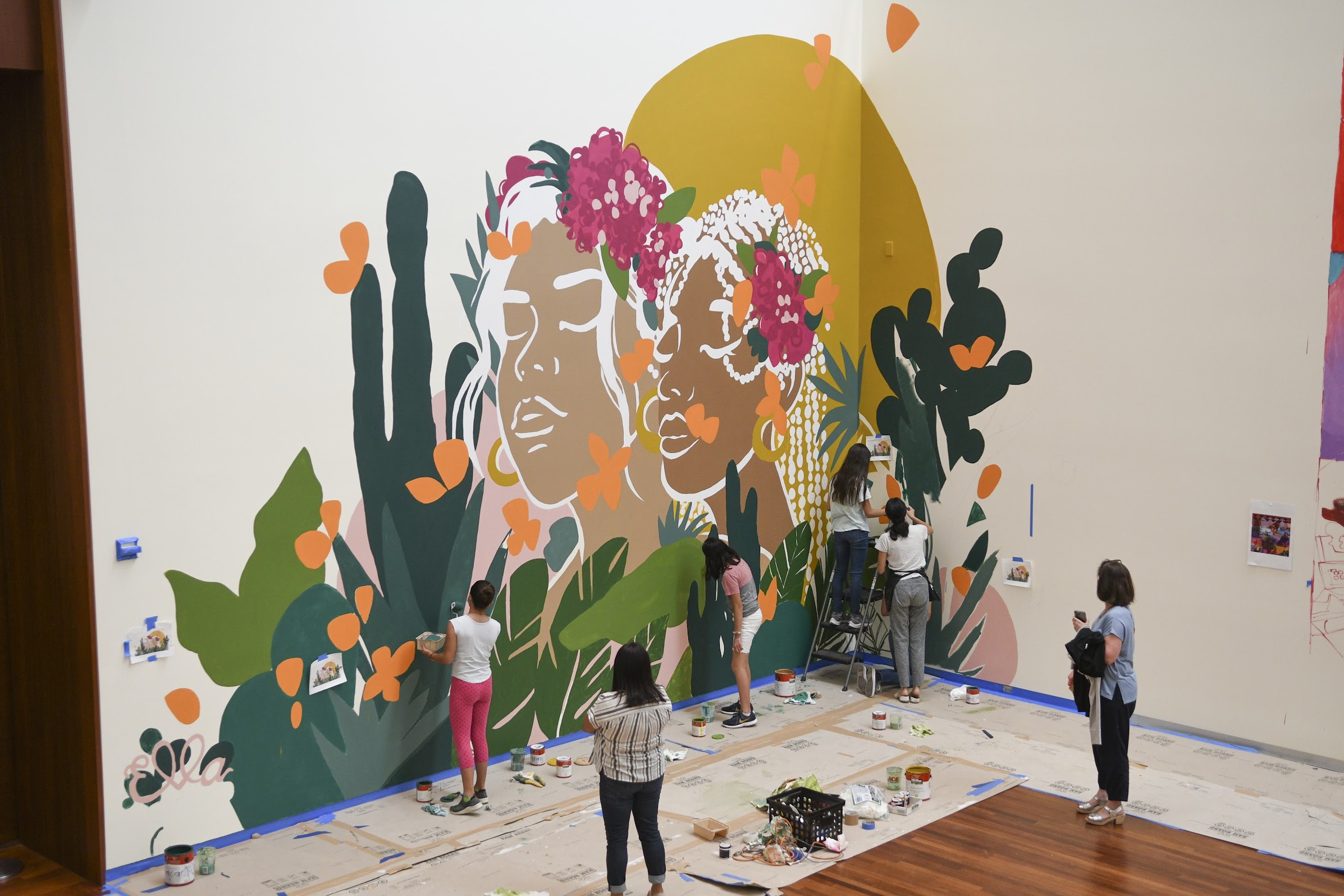 Ella Rises participants painting a mural